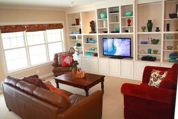 Color blocking the bookcases, and arranging the furniture in a conversation grouping makes this family room appealing.