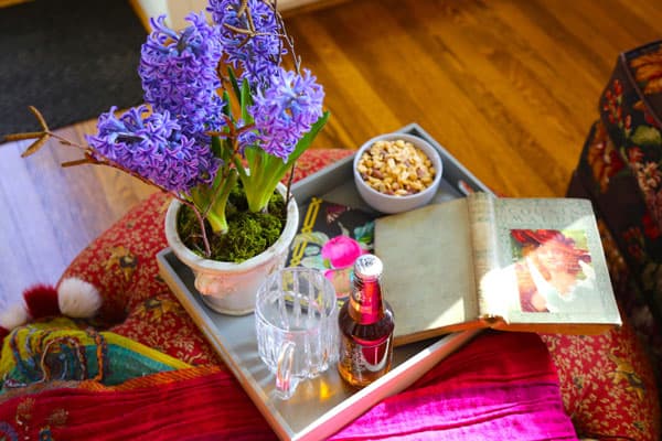 Afternoon snacks await on this ottoman in the sun-soaked sitting room. The spectacular hyacinth’s fragrance fills the room with the scents of Spring.